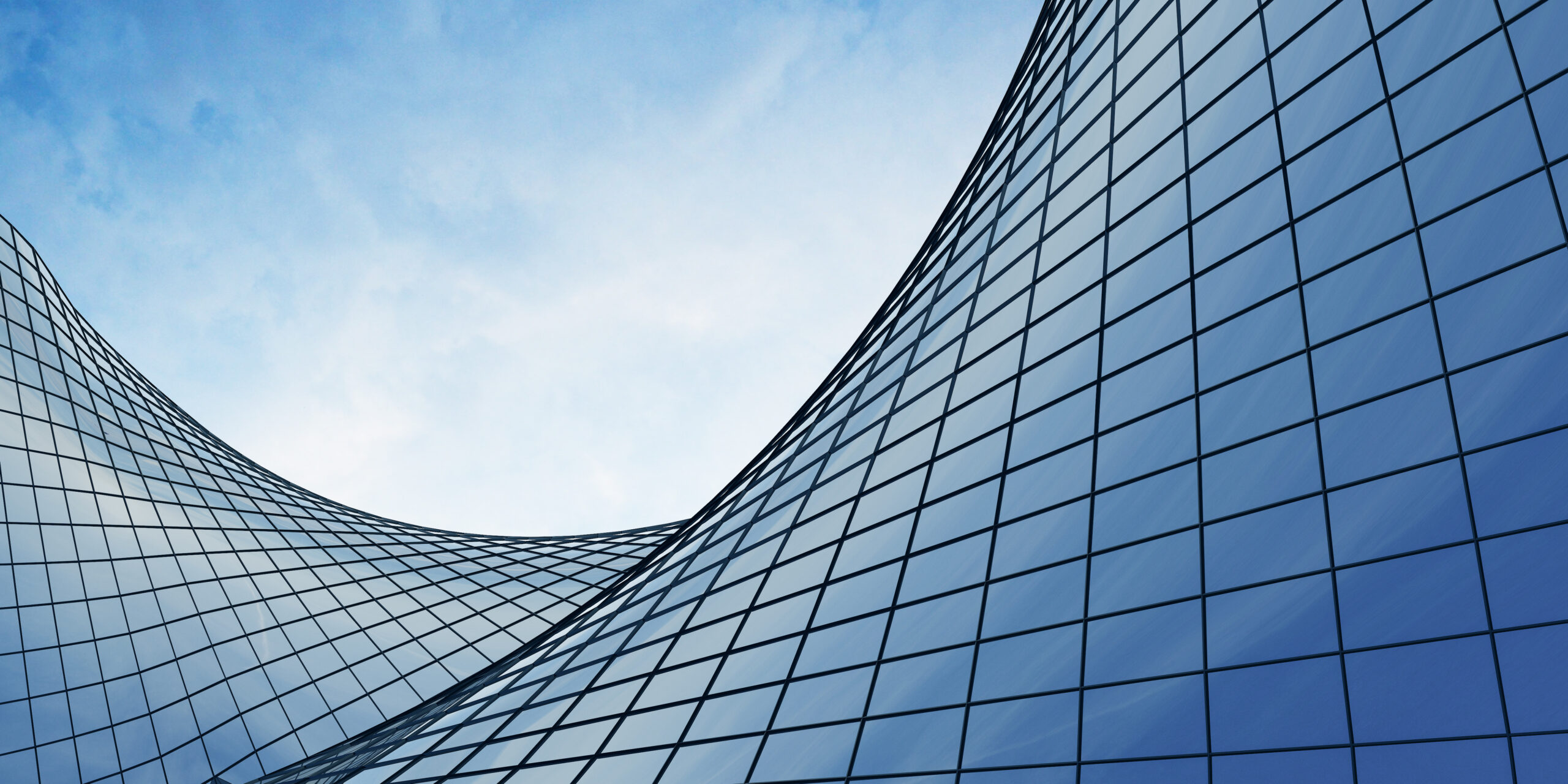 View of the clouds reflected in the curve glass office building.